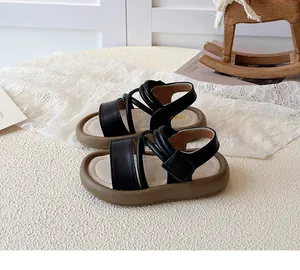 Detail of girls black strappy sandals featuring adjustable velcro closure and non-slip sole