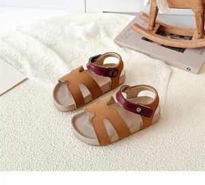 Detail of kids vintage sandals with H-cutout suede and burgundy velcro straps