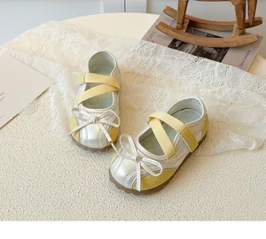 Detail of children's Mary Jane shoe with silver metallic texture and yellow mesh fabric