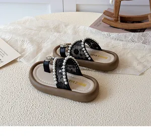 Détail des tongs pour filles en dentelle noire avec perles et fleur en cristal