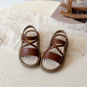 Brown girls leather sandals with open toe and thick rubber sole in a Nordic lifestyle setting