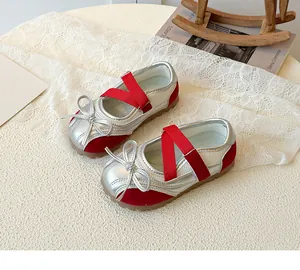 Detail of silver Mary Jane shoes for girls with red elastic straps and non-slip rubber soles