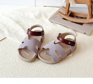 Close-up of girls' purple leather sandal with H-cutout upper and red velcro strap