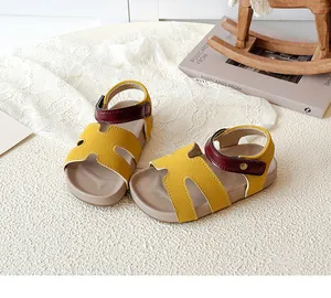 Detail of kids' sandals with yellow H-cut leather, burgundy velcro strap and retro style
