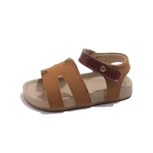 Kids open-toe beach sandals in brown suede with red ankle strap and velcro closure