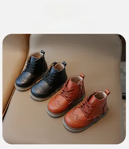 Detail of Brogue pattern and side zipper on children's leather ankle boots
