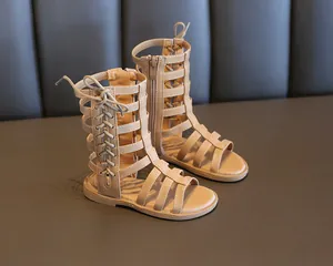Detail of apricot girl's high-top gladiator sandals with cross laces and side zipper