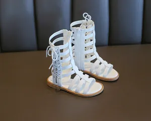 Close-up of girls white gladiator sandals with high-top lace-up design and back zipper