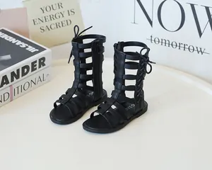 Detail of black gladiator sandals featuring multi-strap hollow design and side zipper closure