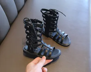 Detailed view of girls black Roman sandals featuring a high-top design and side zipper
