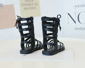 Detail view of black girl's high-top gladiator sandals with rear zipper and lace-up design