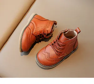 Detail view of children's brown leather boots with Brogue carving and side zipper