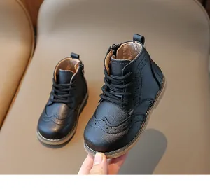 Macro detail of children's black leather boots featuring brogue perforation and side zipper
