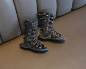 Detail view of black PU leather gladiator sandals with side zipper and lace-up straps
