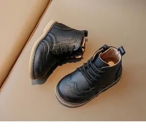 Detail of children's black Brogue boots showing leather texture and side zipper