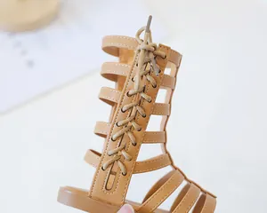 Detail of camel high-top Roman sandals for girls with stylish criss-cross bow lace-up design