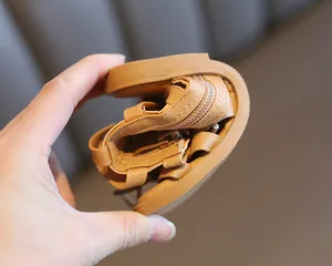Flexible rubber sole of brown girls' Roman sandals showing high durability and bendability