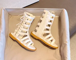 Detail of white gladiator sandals for girls with side zipper and strap closure
