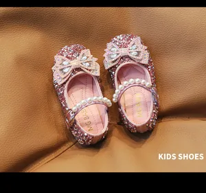 Detalle de zapatos de princesa rosas para niña con lentejuelas y perlas brillantes