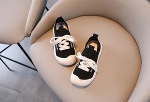 Detail of children's knitted sneakers showing breathable mesh and rubber toe cap