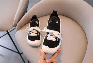 Close-up of kids mesh chunky sneakers with thick white soles and MMG BABY logo
