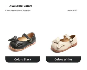 Detail view of girls' Mary Jane shoes with bow decoration in black and beige colors
