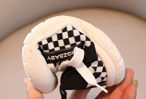 Detailed macro shot showcasing the flexible soft rubber sole of children sports shoes