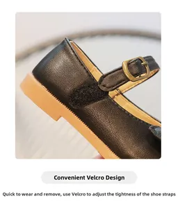 Close-up of girls' black Mary Jane shoe featuring convenient adjustable hook and loop strap