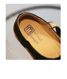 Detail showing soft skin-friendly inner lining and velcro strap of black Mary Jane shoes