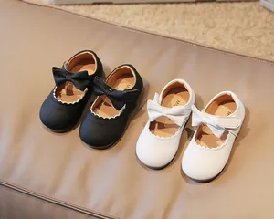 Detail of baby girl Mary Jane shoes with bow decoration and scalloped edge detail