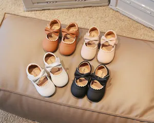 Overhead shot of baby girl Mary Jane shoes with bows in brown, pink, white, and black