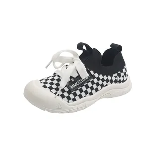 Kids chunky sneakers with black and white checkerboard pattern and white bumper toe