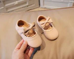 Close-up of pink toddler princess shoes with bow decoration and velcro strap detail