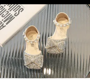 Détail de chaussures princesse pour filles avec strass, nœud et bride en perles