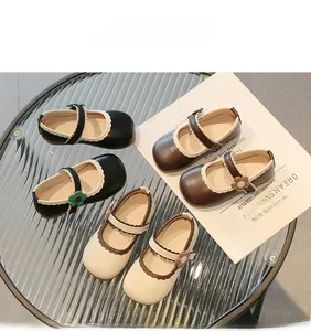 Detailed macro view of girls Mary Jane shoes in black brown and beige leather colors