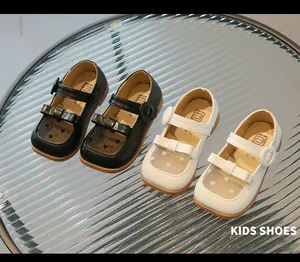 Detail of girls' Mary Jane shoes with heart mesh, bows and non-slip rubber soles