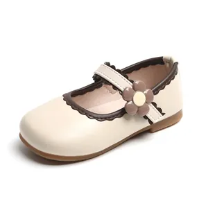 Girls cream Mary Jane shoes with brown flower detail and wavy edges on white background