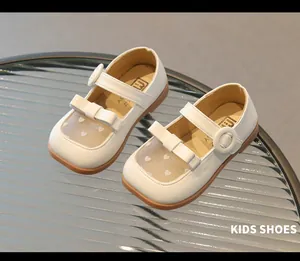 Close-up of white girls' sandals with heart mesh, bow detail and rubber sole