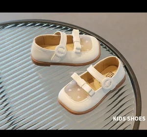 Macro view of kids Mary Jane shoes with mesh heart patterns and cute bow decoration