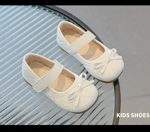 Détail de chaussures Mary Jane matelassées blanches avec double nœud pour filles