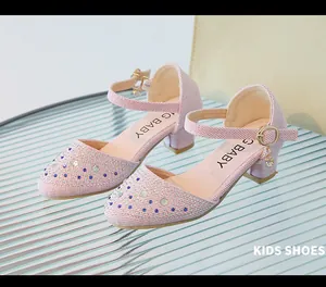 Detalle de zapato de princesa rosa con purpurina, pedrería y hebilla metálica de correa