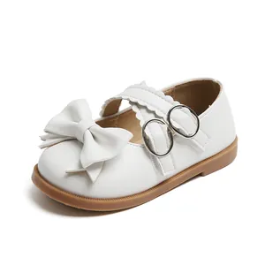 Elegant girls white princess shoes with decorative bows and scalloped lace straps