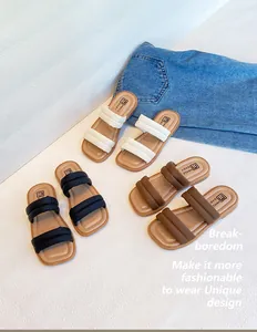 Detailed top view of soft double-strap toddler sandals in beige, black, and brown