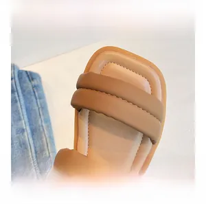 Detailed macro shot of brown square-toe sandals with puffy straps and soft PU leather