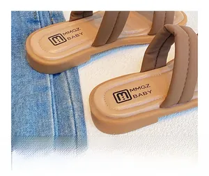 Detailed view of soft brown leather heel strap on stylish baby sandals with logo detail