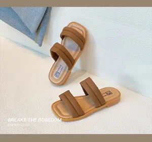 Detail of puffy caramel double-strap kid's sandals featuring non-slip rubber soles and soft footbed