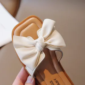 Girl's cream open-toe sandals with large bow detail and soft sole for summer wear