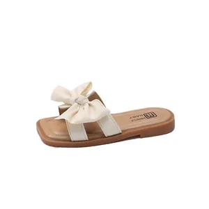 Kids stylish open-toe sandals with elegant bows and soft rubber soles in beige