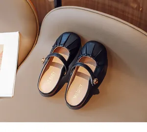 Top-down view of black Mary Jane girls' shoes featuring pleated toes and floral buckles