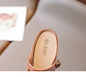 Detail of girls brown leather mules with MG.BABY gold logo and soft cushioned sole